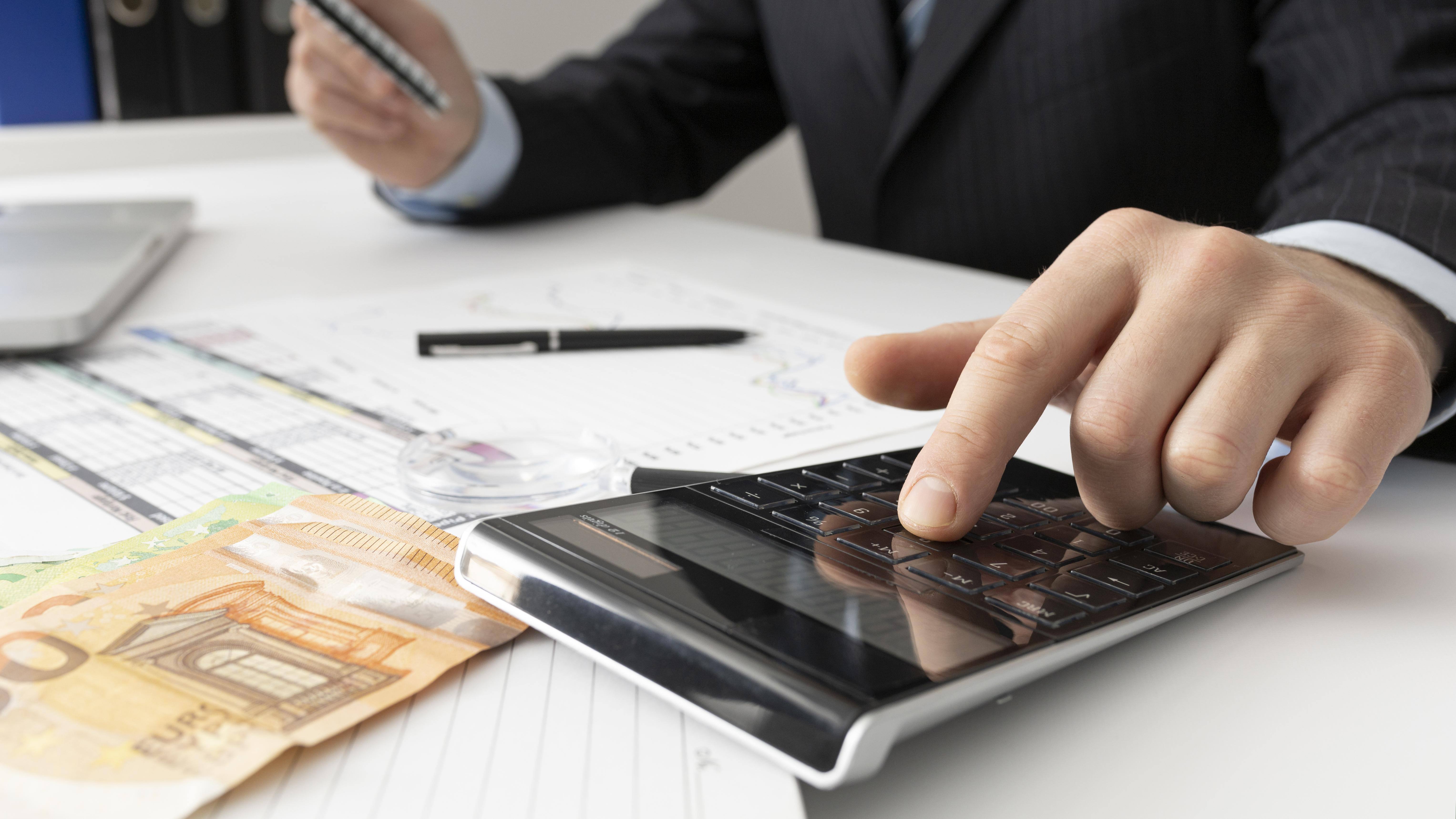 business-man-calculating-finance-numbers-close-up