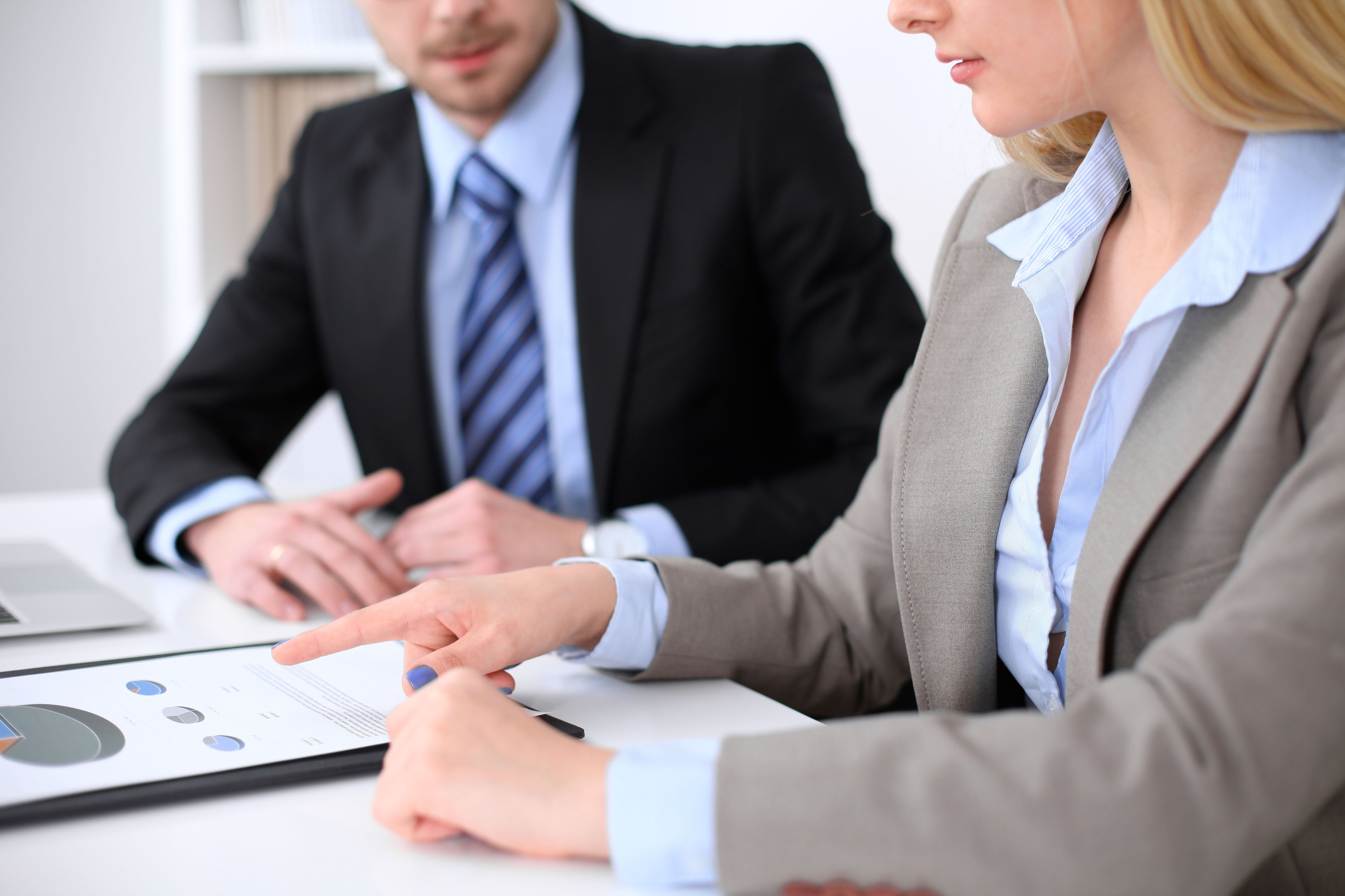 business-woman-pointing-into-financial-figure-talking-with-her-male-partner-close-up-hands
